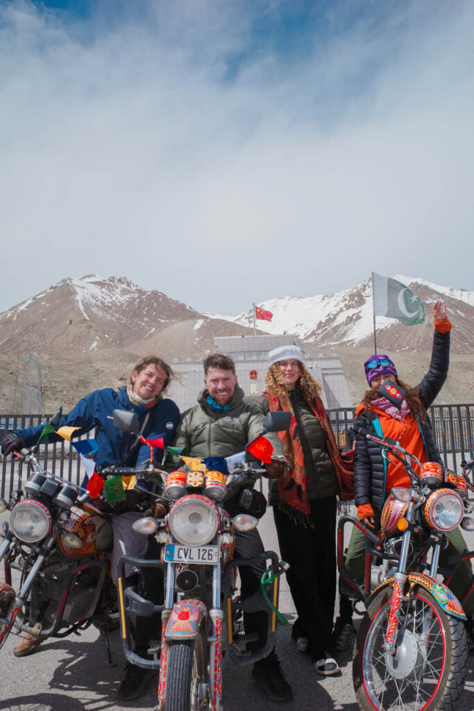 Elsewheria riders with their motorbikes at Khunjerab Pass on the Pakistan Mountain Motorbiking Adventure
